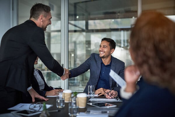 Business people closing a deal by shaking hands