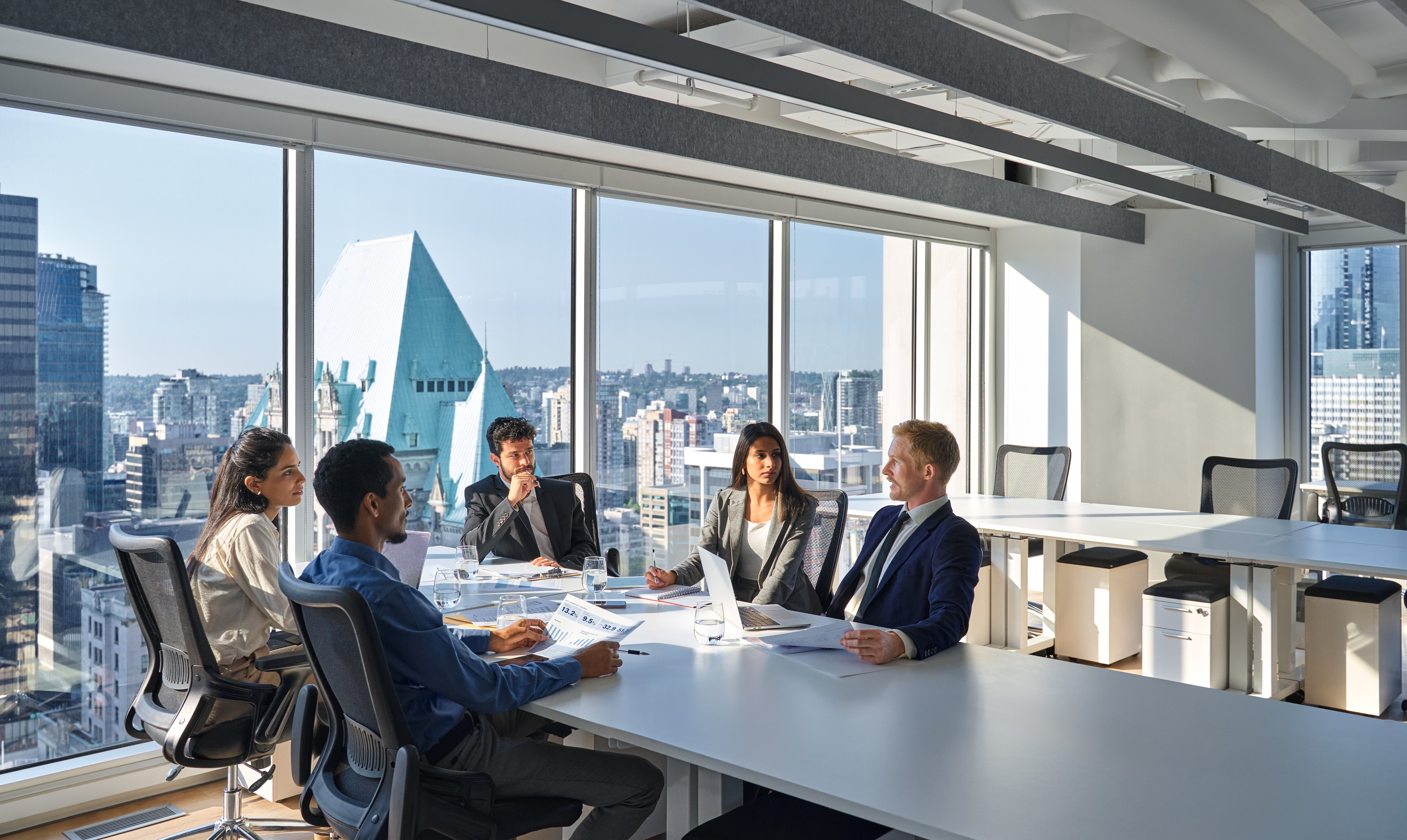 In a boardroom overlooking the city, company executives have an important discussion   